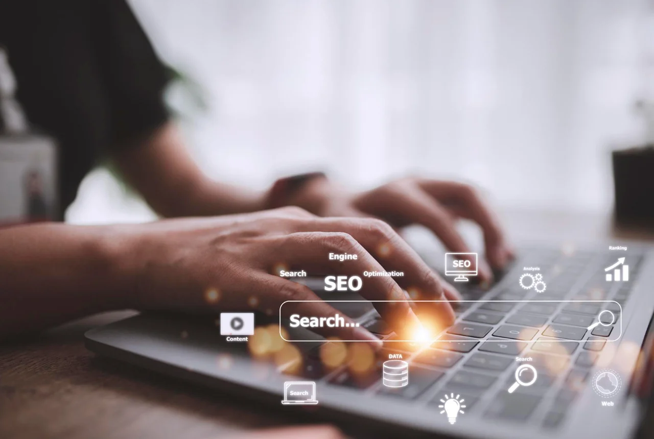 Pessoa a analisar dados de crescimento orgânico e métricas de SEO num portátil num ambiente de escritório.